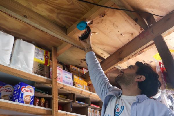 CEO of Lumkani installing a fire alarm