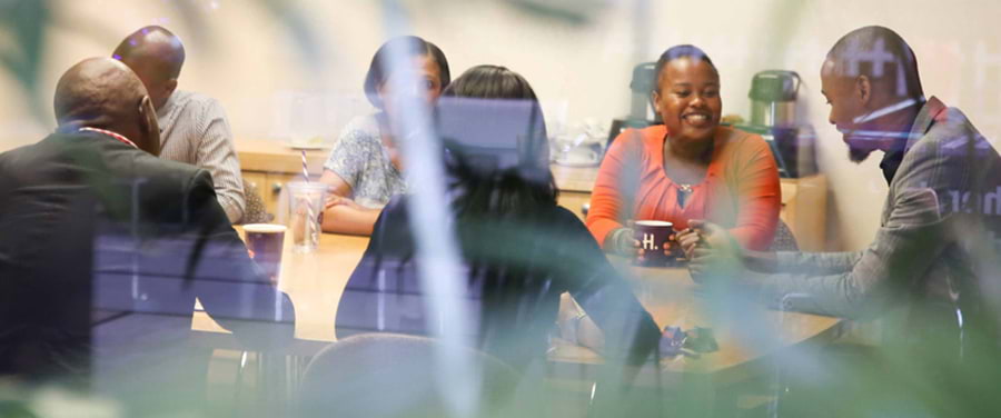 Hollard B-BBEE group gathered around a table in the office