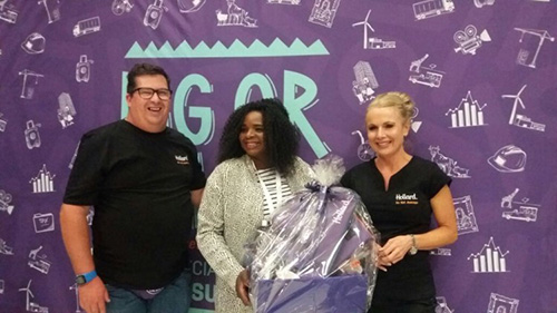 Muofhe Radzilani, holding the #stibs2017 Hollard hamper with two Hollard employees