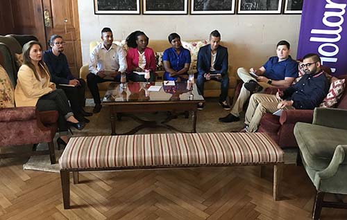 Insurance Apprentice participants sitting on couches around a coffee table