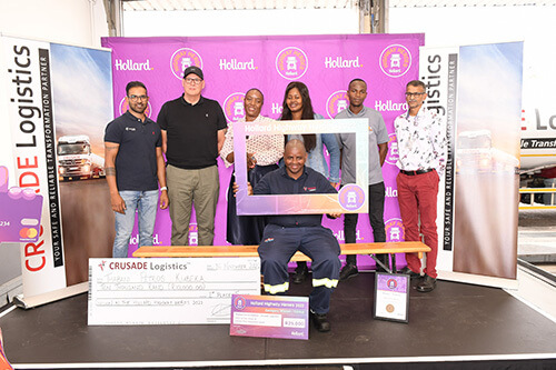 Thabani Kubeka and Crusade Logistics team on stage with his award